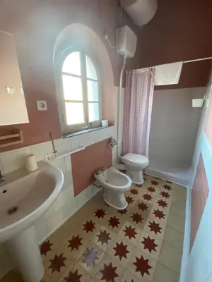 a bathroom with a sink and a toilet at Tranvía Beach House in Chipiona