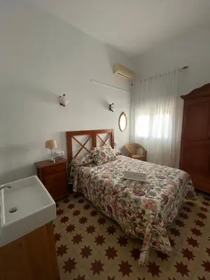 a bedroom with a bed and a sink in it at Tranvía Beach House in Chipiona