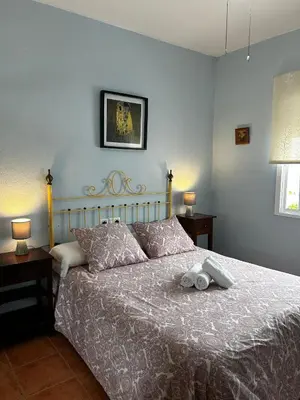 a bedroom with a bed with a stuffed animal on it at La Casa del Camaleon in Chipiona