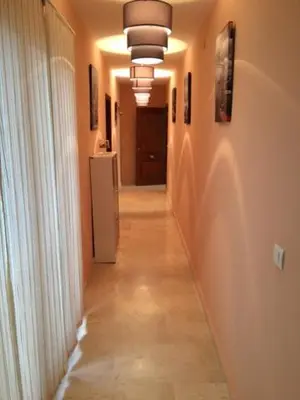 a hallway with a long hallway with a long hallwayngthngthngthngthngthngth at Apartamentos Doñana in Sanlúcar de Barrameda