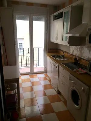 a kitchen with a sink and a counter top at Apartamentos Doñana in Sanlúcar de Barrameda