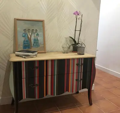 a dresser with a picture on top of it at Hostal Boutique La Española in Rota