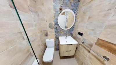 a bathroom with a toilet and a sink and a mirror at Hostal Boutique La Española in Rota