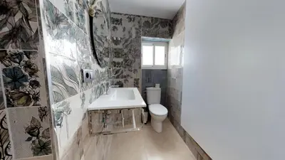 a bathroom with a white toilet and a sink at Hostal Boutique La Española in Rota