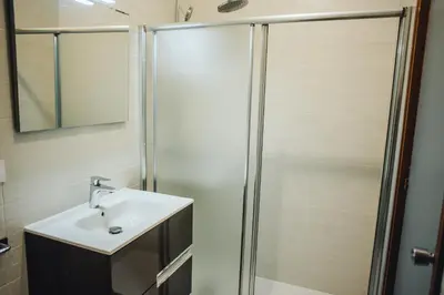 a bathroom with a sink and a shower at Casa Cordoba in Chipiona