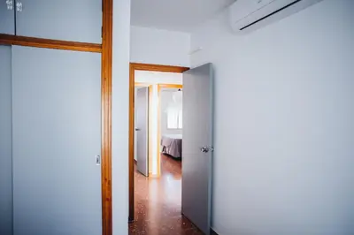 a hallway with an open door to a bedroom at Casa Cordoba in Chipiona