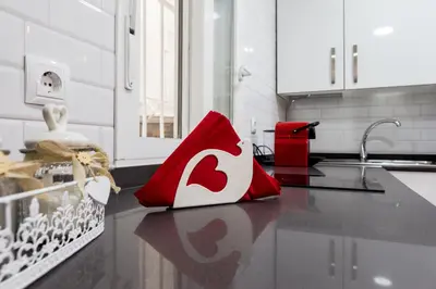a red and white bag sitting on a kitchen counter at Catedral Cadiz in Cádiz