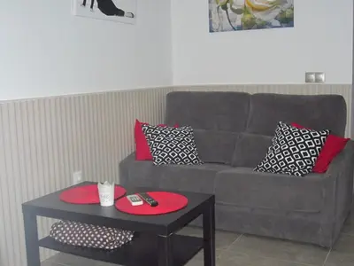 a living room with a couch and a table at Botic4 in Cádiz