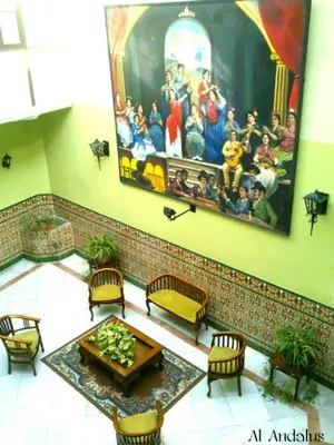 a room with a painting on the wall and a table at Al Andalus Jerez in Jerez de la Frontera