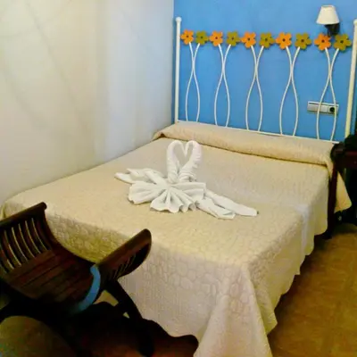 a bedroom with a bed with a flower on it at Al Andalus Jerez in Jerez de la Frontera