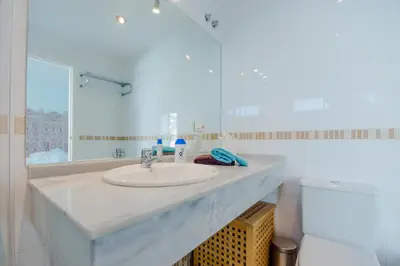 a hotel room with two beds and a window at Casas Fuente del Sol in Conil de la Frontera