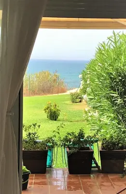 a room with a large glass window with plants in it at Casas Fuente del Sol in Conil de la Frontera
