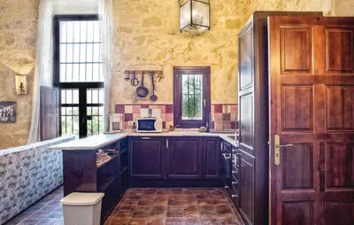 a kitchen with wooden cabinets and a counter top at Jerez Viña Santa Petronila in Jerez de la Frontera