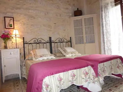 a bedroom with a large bed with a pink blanket at Jerez Viña Santa Petronila in Jerez de la Frontera
