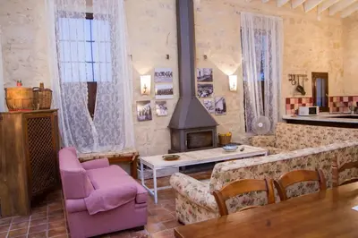 a living room with a couch and a fireplace at Jerez Viña Santa Petronila in Jerez de la Frontera