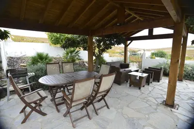 a patio with a table and chairs under a pavilion at Jerez Viña Santa Petronila in Jerez de la Frontera