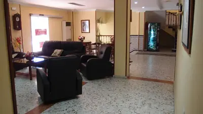 a living room with a couch and chairs and a table at Hotel Catalán Puerto Real in Puerto Real