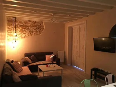a living room with a couch and a table at Casa Bugambilla Cadiz in Cádiz