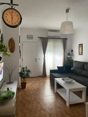 a living room with a couch and a table at Tabano in Chipiona