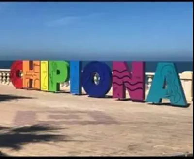 a sign that says papaya painted on the beach at Tabano in Chipiona