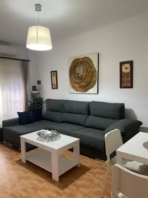 a living room with a couch and a table at Tabano in Chipiona