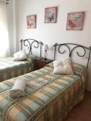 two beds in a room with two pillows on them at Tabano in Chipiona