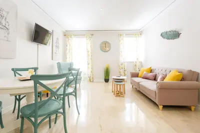 a living room with a couch and a table and chairs at Apartamento El SABIO by Cadiz4Rentals in Cádiz