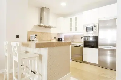 a kitchen with stainless steel appliances and white cabinets at Apartamento El SABIO by Cadiz4Rentals in Cádiz
