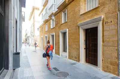 a woman walking down a city street at Apartamento El SABIO by Cadiz4Rentals in Cádiz