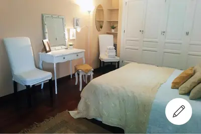 a bedroom with a bed and a sink and a mirror at Piso Ribera del Marisco in El Puerto de Santa María