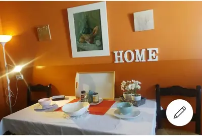 a dining room table with a home sign on the wall at Piso Ribera del Marisco in El Puerto de Santa María