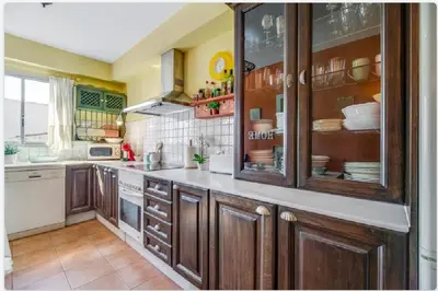 a large kitchen with wooden cabinets and appliances at Piso Ribera del Marisco in El Puerto de Santa María
