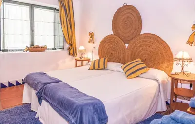 a bedroom with a large bed with a large wooden headboard at Beautiful Home In Arcos De La Frontera in Arcos de la Frontera