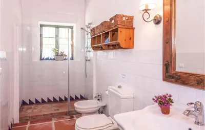 a white bathroom with a toilet and a sink at Beautiful Home In Arcos De La Frontera in Arcos de la Frontera