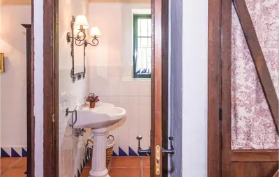 a bathroom with a sink and a toilet and a mirror at Beautiful Home In Arcos De La Frontera in Arcos de la Frontera