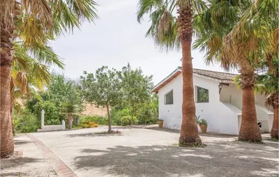 a white house with palm trees in front of it at Beautiful Home In Arcos De La Frontera in Arcos de la Frontera