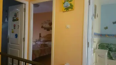 a hallway leading to a bedroom with a bed at Isabelita in Rota