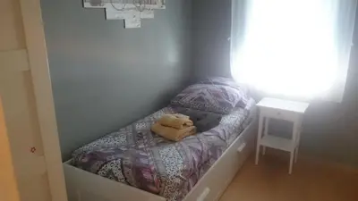 a teddy bear sitting on a bed in a room at Isabelita in Rota
