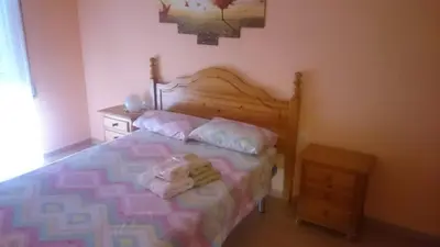a bedroom with a bed with towels on it at Isabelita in Rota