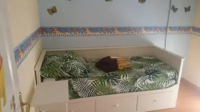 a bed in the corner of a room at Isabelita in Rota