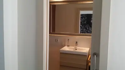 a bathroom with a sink and a mirror at Estudio Deluxe Playa de la Victoria in Cádiz