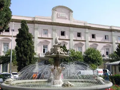 a water fountain in front of a large building at Estudio Deluxe Playa de la Victoria in Cádiz