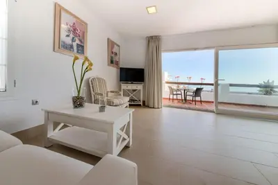a white living room with a view of the ocean at Villas Flamenco Beach Conil in Conil de la Frontera