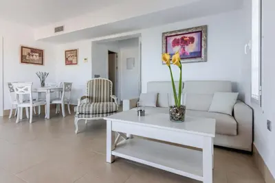 a living room with a couch and a table at Villas Flamenco Beach Conil in Conil de la Frontera