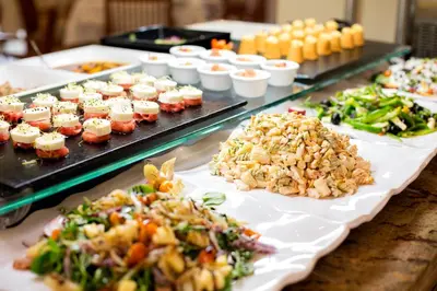 a buffet filled with different types of food on plates at Hipotels Flamenco Conil in Conil de la Frontera