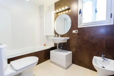 a bathroom with a toilet and a sink and a mirror at El Atico del MARQUES free parking by Cadiz4Rentals in Cádiz