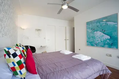 a bedroom with a bed and a ceiling fan at El Atico del MARQUES free parking by Cadiz4Rentals in Cádiz