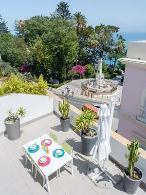 a patio with a table and chairs and a fountain at El Atico del MARQUES free parking by Cadiz4Rentals in Cádiz