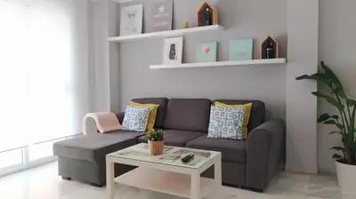 a living room with a couch and a table at Sherryflat Caballeros - Parking in Jerez de la Frontera
