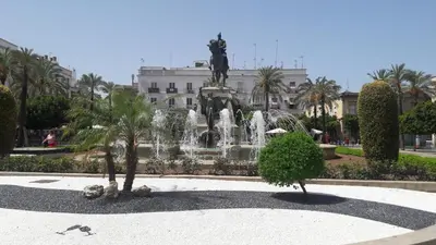 a fountain with a statue in front of a building at Sherryflat Caballeros - Parking in Jerez de la Frontera